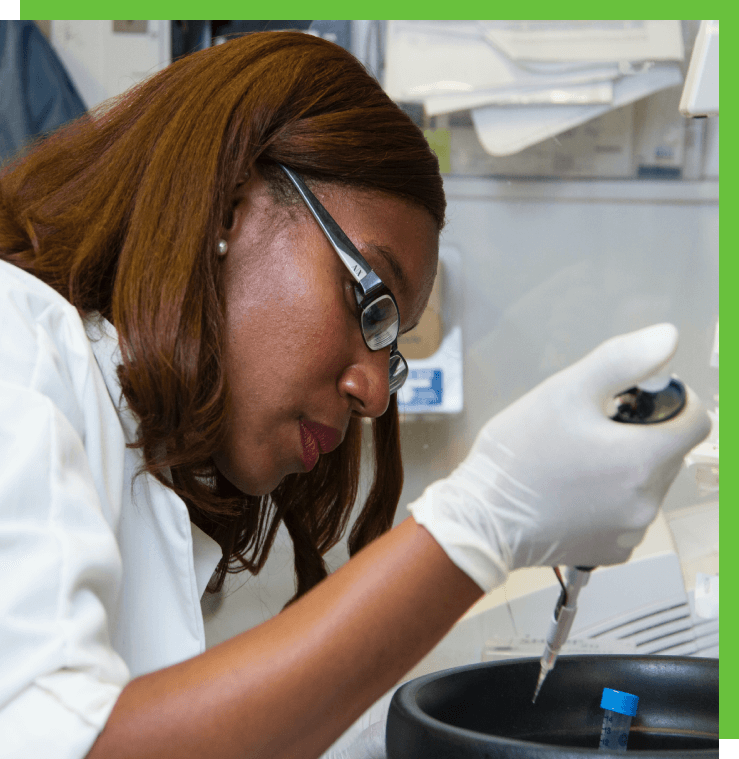 Woman scientist using a pipette in a lab.