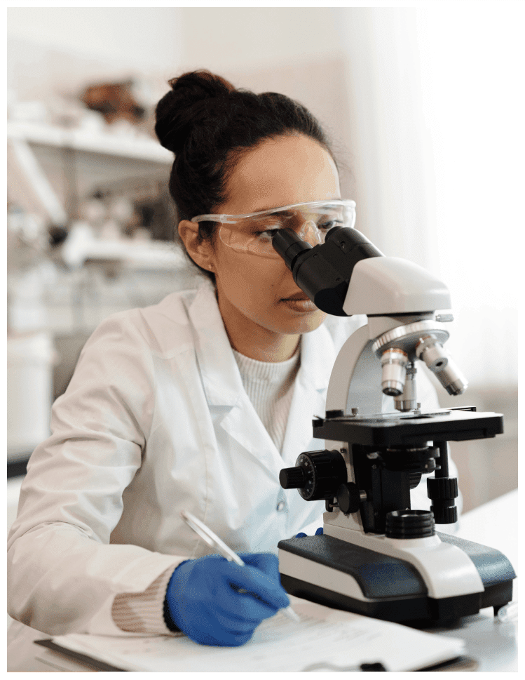 Scientist looking through a microscope.