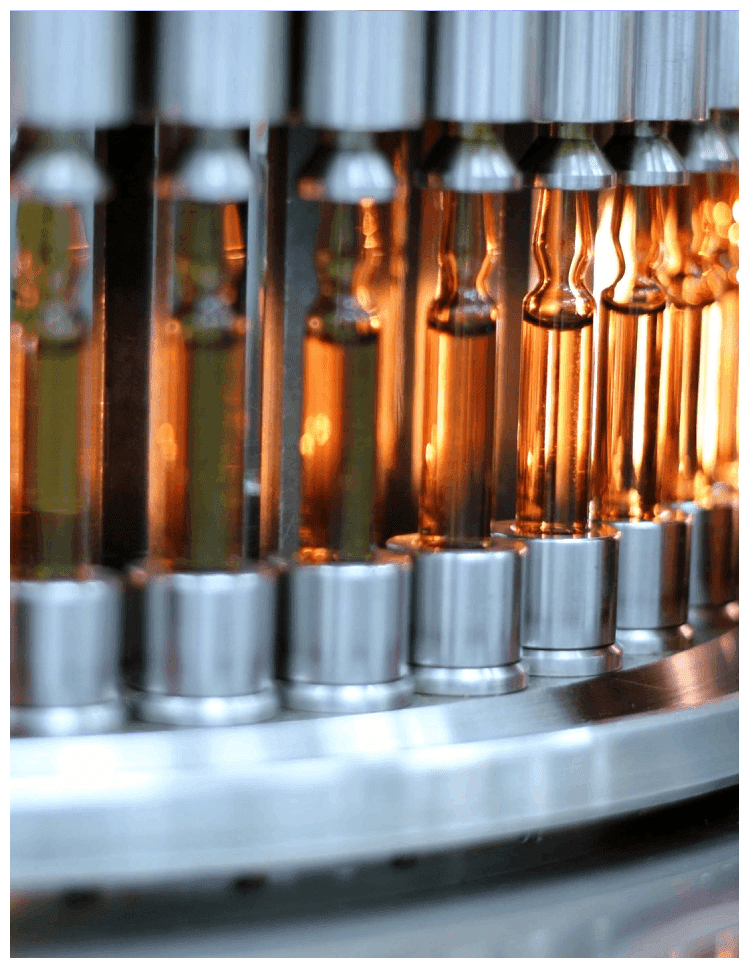 A row of glass vials on a machine.